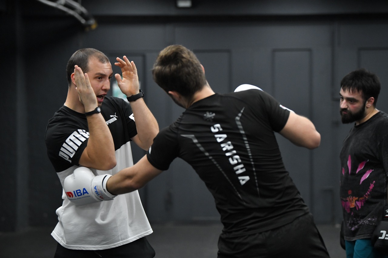 Boxing athletes training under coach supervision in Tbilisi